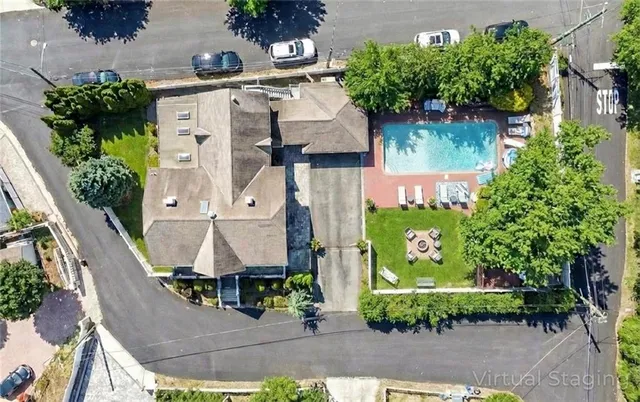 an aerial view of residential houses with outdoor space and parking
