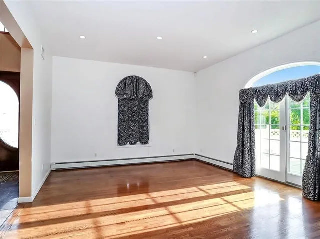a view of room with window and wooden floor