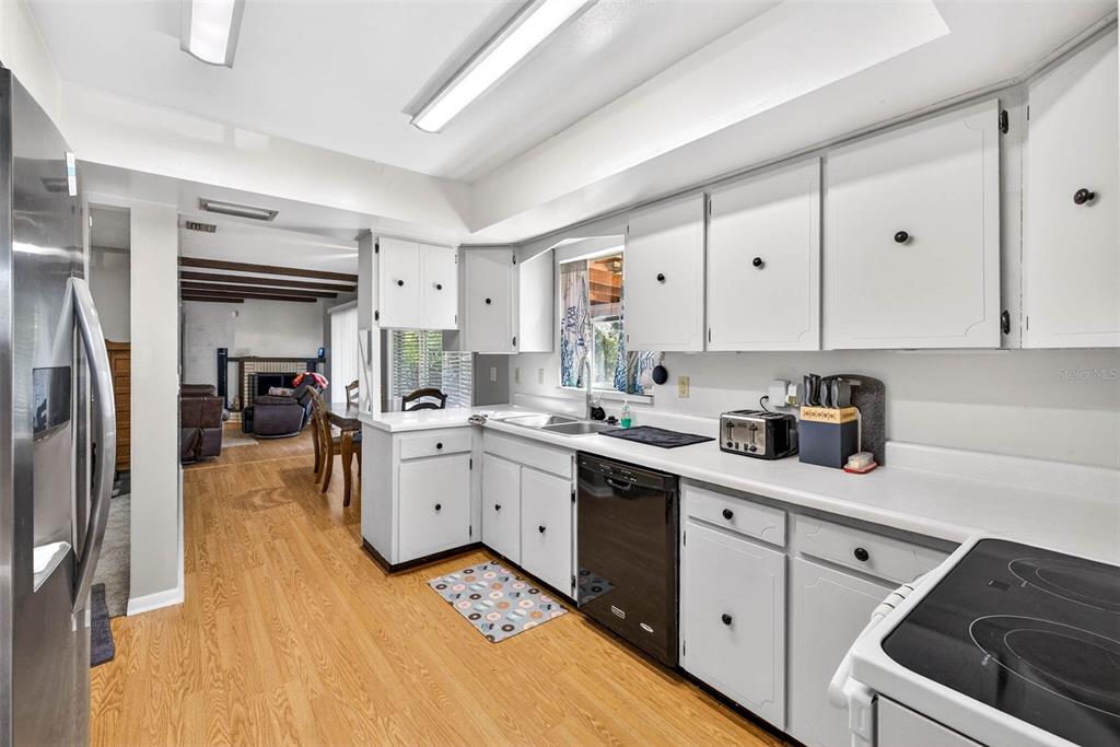 619 Limona Road Brandon, FL 33510 - Photo 11 of 32 a kitchen with a sink dishwasher and white cabinets
