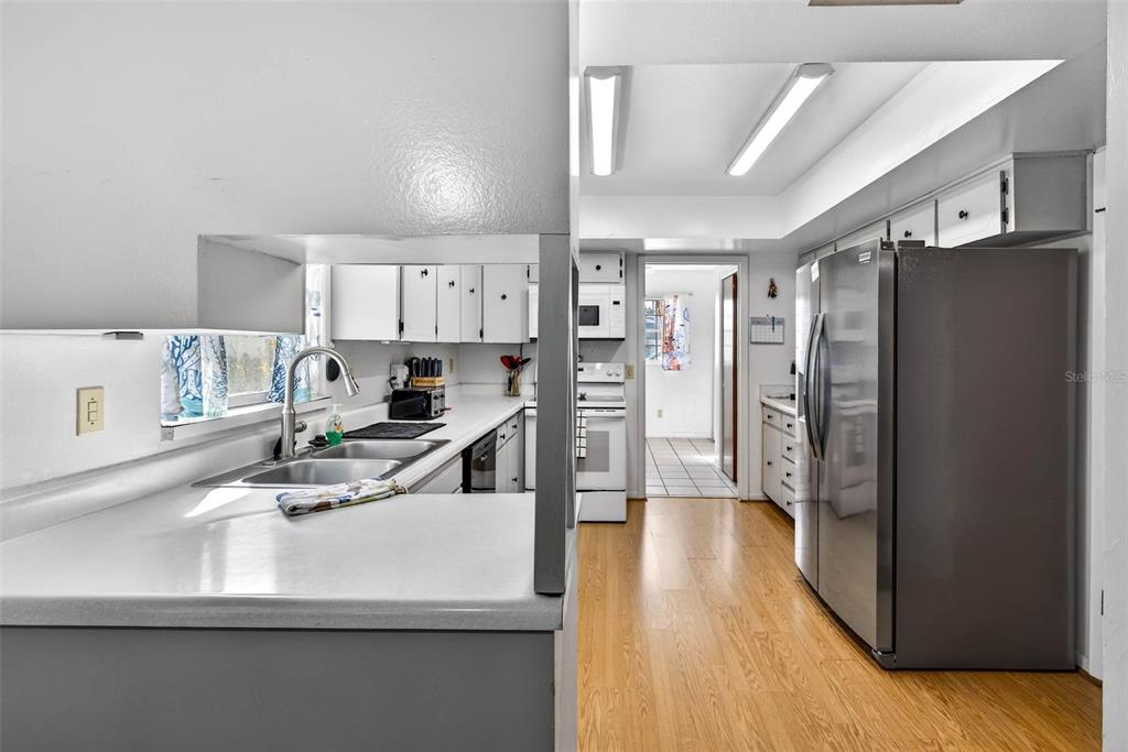 619 Limona Road Brandon, FL 33510 - Photo 12 of 32 a kitchen with stainless steel appliances granite countertop a refrigerator and a sink