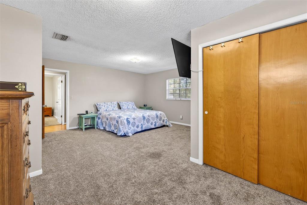 619 Limona Road Brandon, FL 33510 - Photo 26 of 32 a bedroom with a bed and a large window
