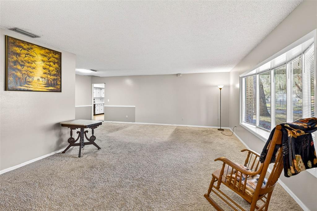 619 Limona Road Brandon, FL 33510 - Photo 7 of 32 a living room with furniture and a floor to ceiling window