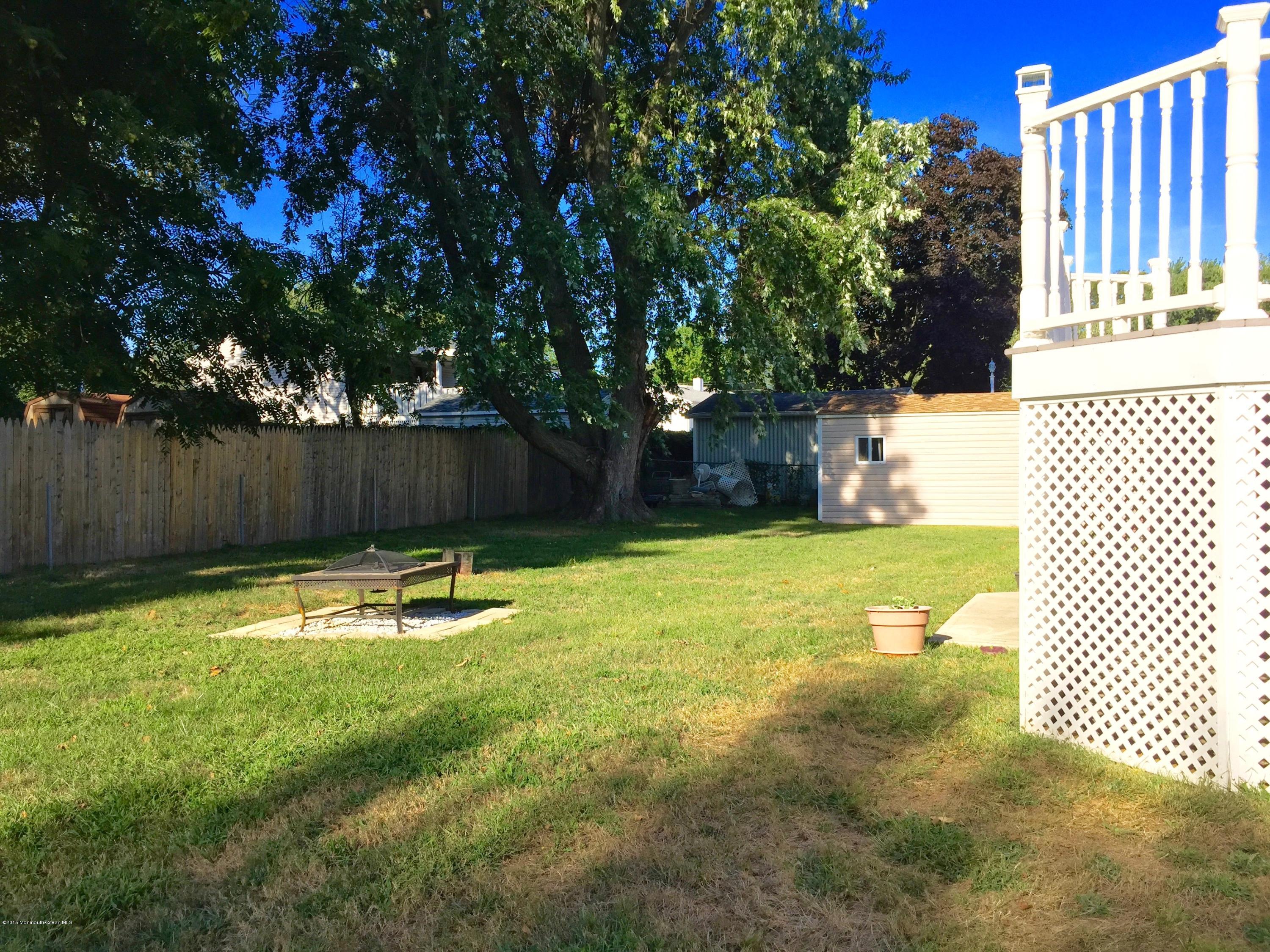 1 Alfred Court Neptune Township, NJ 07753 - Photo 11 of 26 a swimming pool with wooden fence
