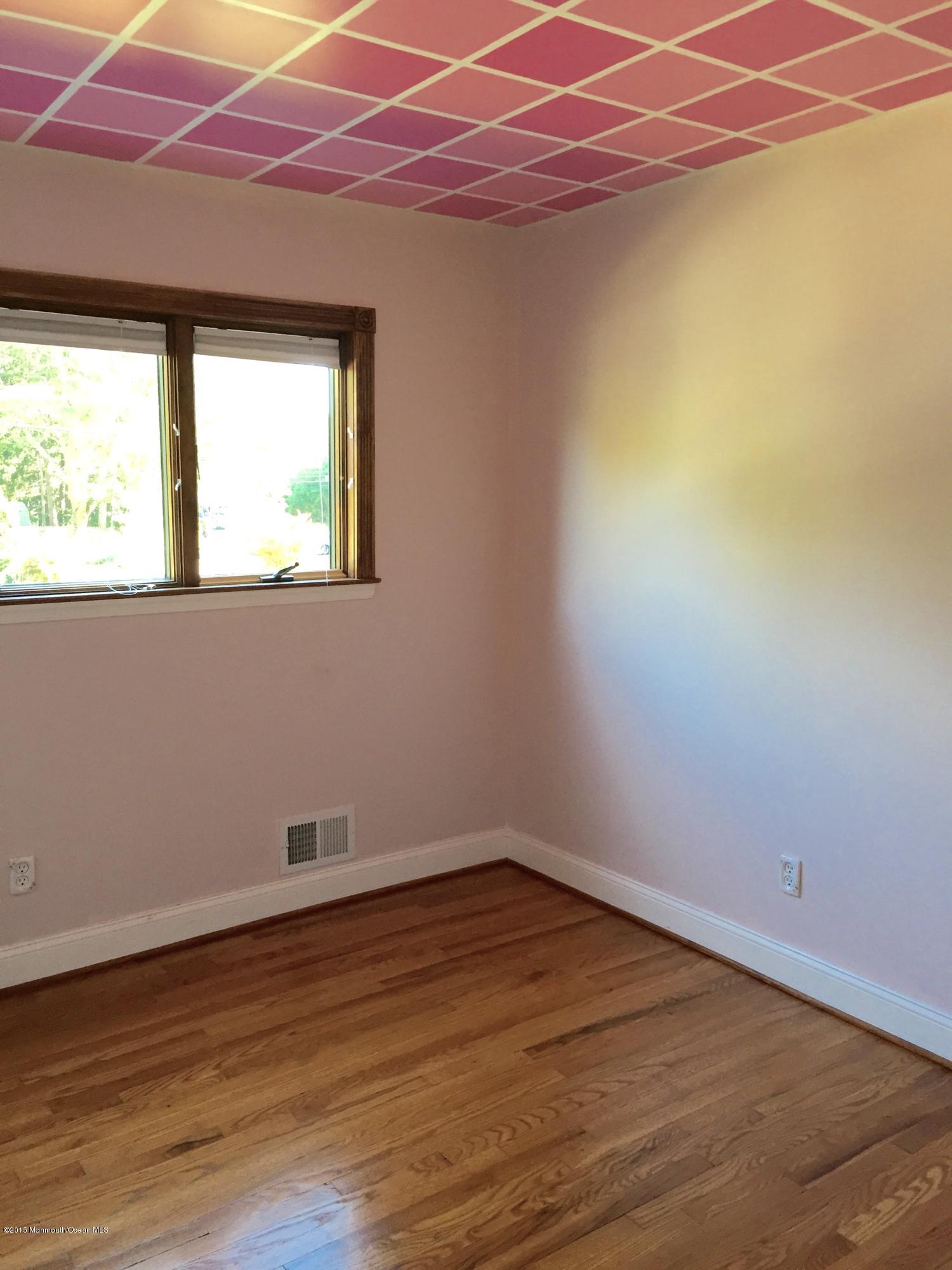 1 Alfred Court Neptune Township, NJ 07753 - Photo 16 of 26 a room with wooden floor and a window