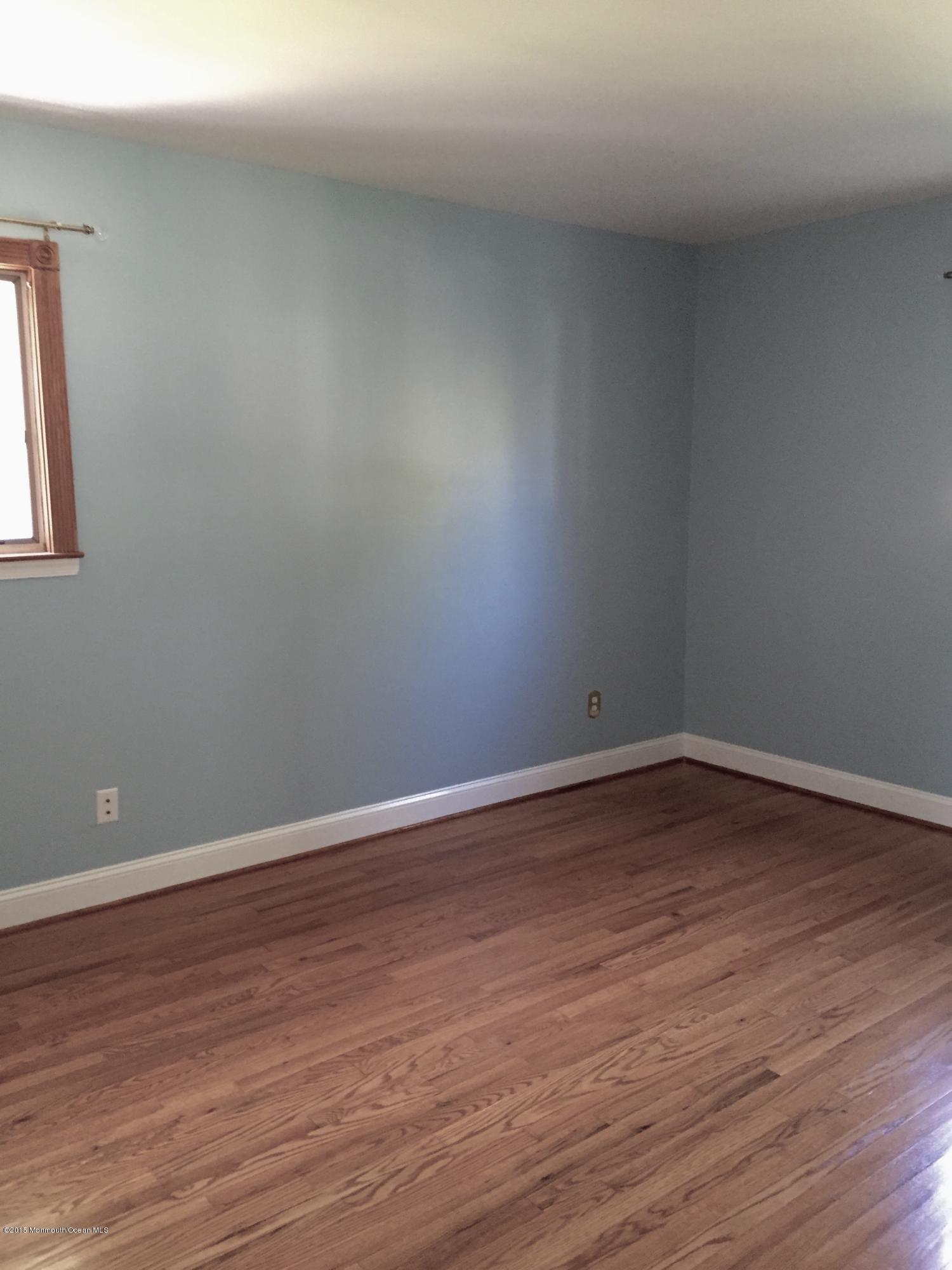 1 Alfred Court Neptune Township, NJ 07753 - Photo 17 of 26 a view of an empty room with wooden floor and a window