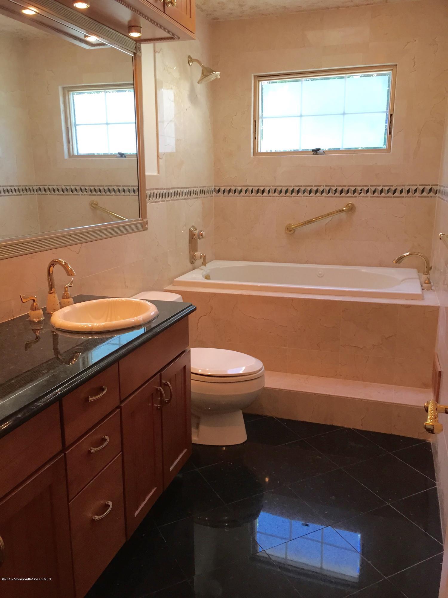 1 Alfred Court Neptune Township, NJ 07753 - Photo 18 of 26 a bathroom with a sink a toilet and shower