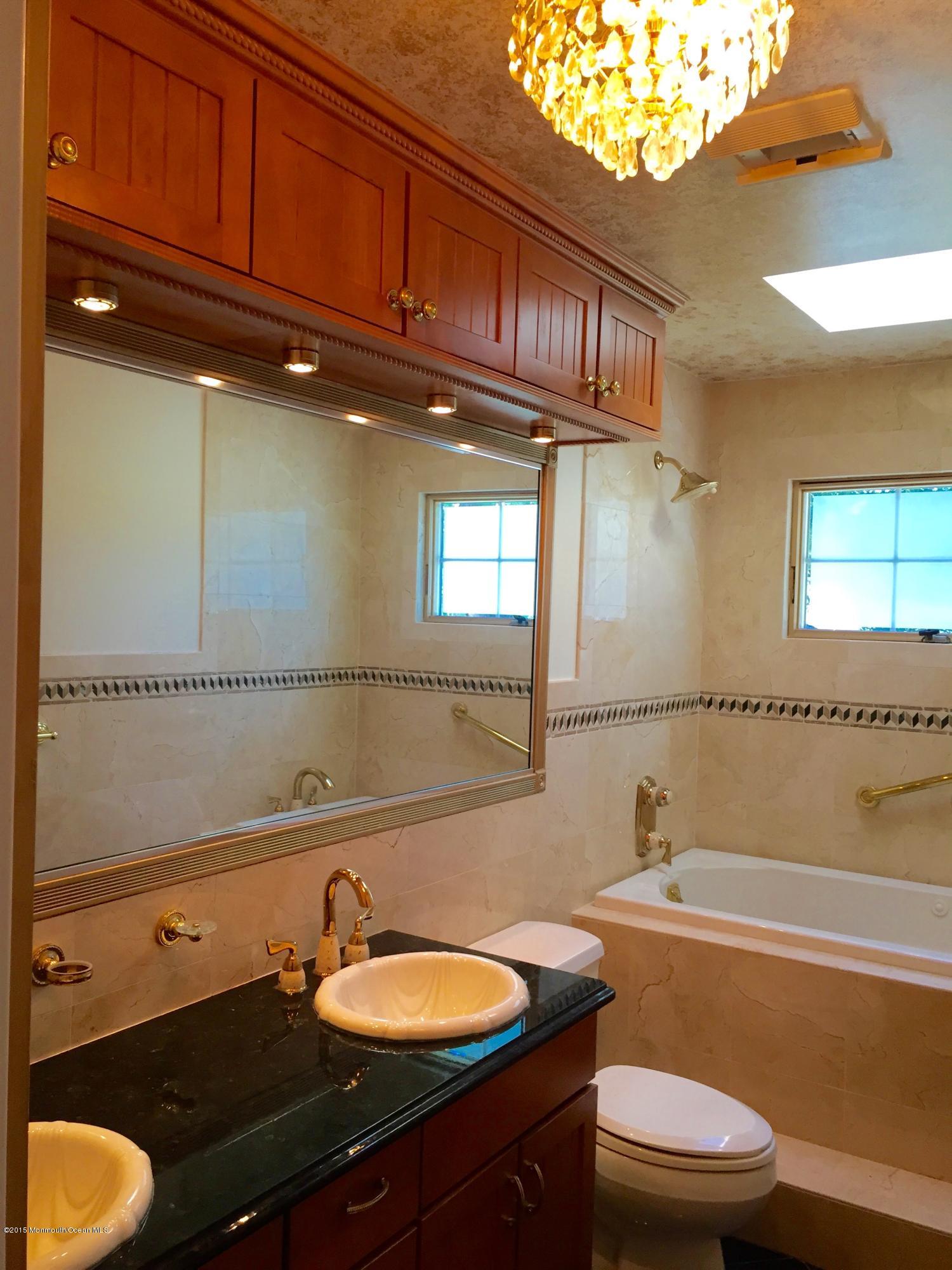 1 Alfred Court Neptune Township, NJ 07753 - Photo 19 of 26 a bathroom with a sink a toilet and bathtub