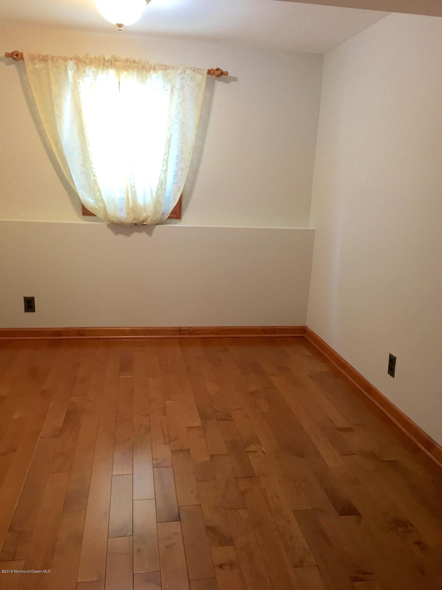 1 Alfred Court Neptune Township, NJ 07753 - Photo 21 of 26 an empty room with a wooden floor and window