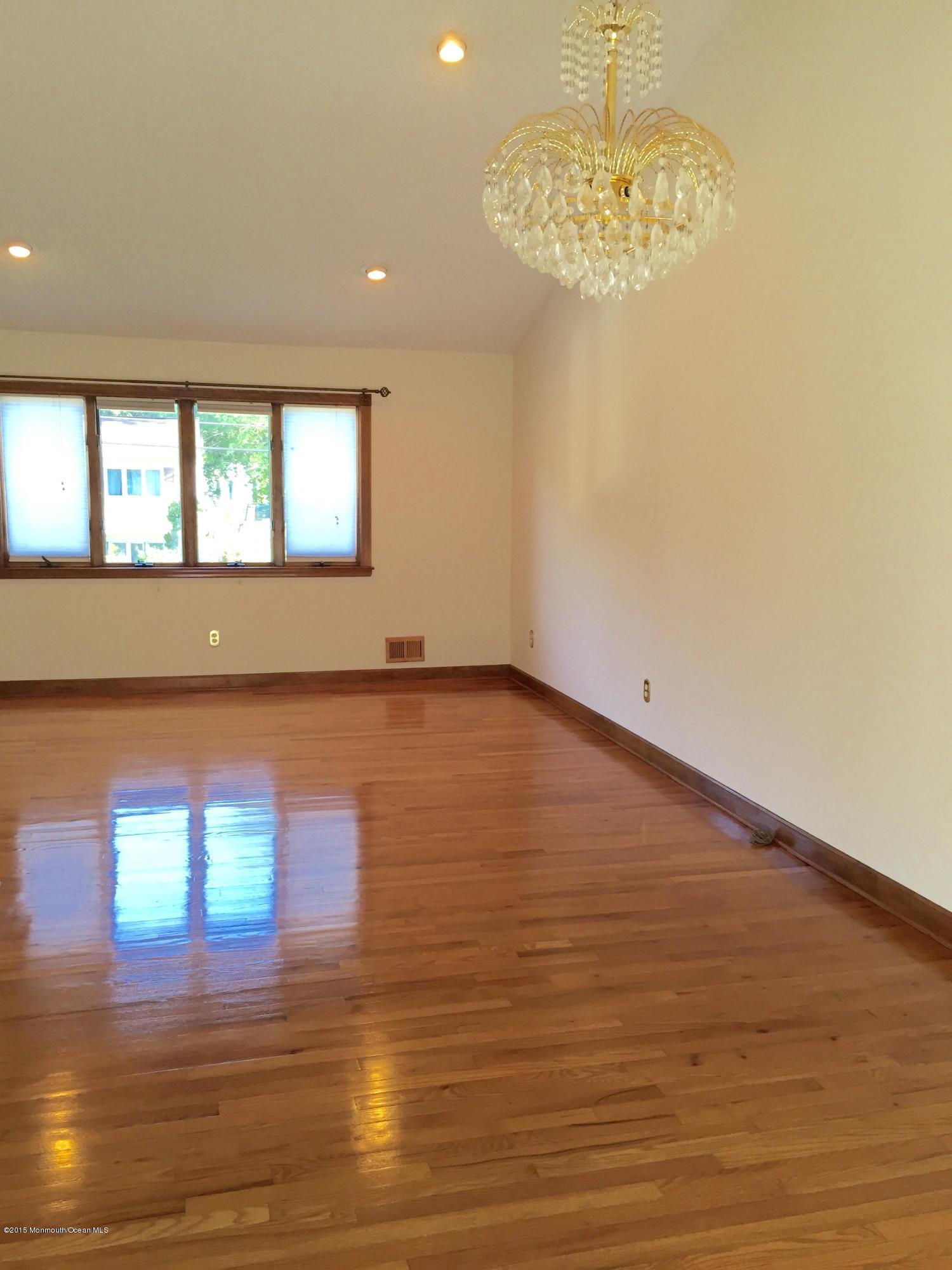 1 Alfred Court Neptune Township, NJ 07753 - Photo 6 of 26 a view of empty room with wooden floor and fan