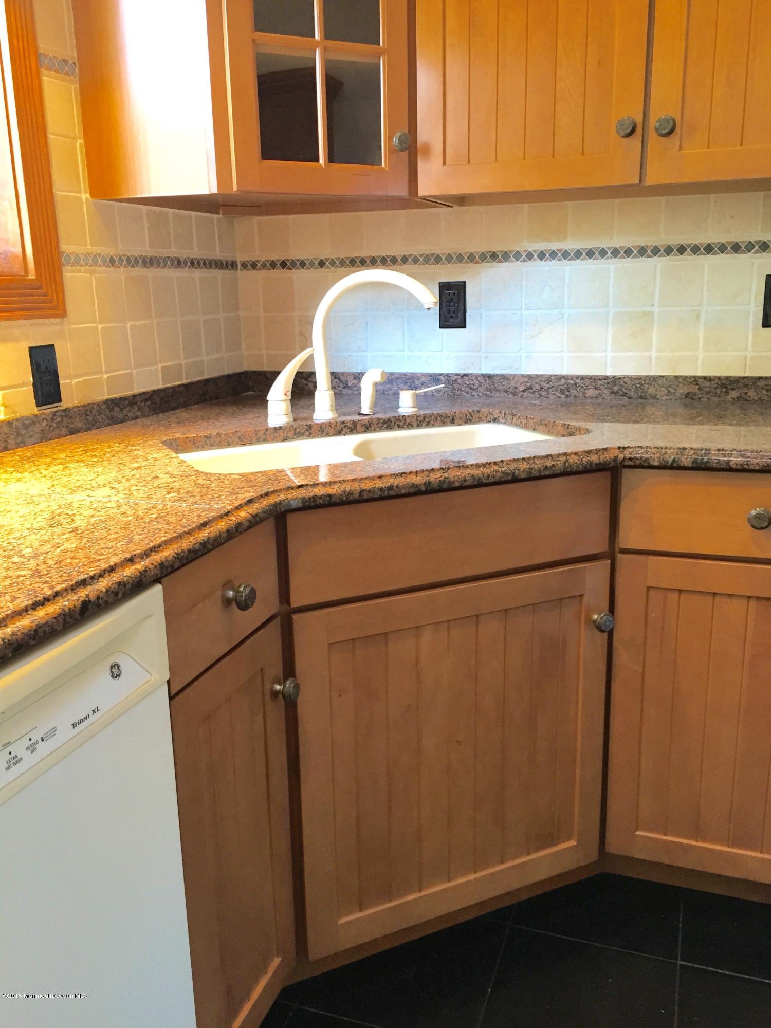 1 Alfred Court Neptune Township, NJ 07753 - Photo 7 of 26 a kitchen with granite countertop cabinets stainless steel appliances and a sink