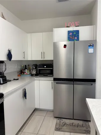 a white refrigerator freezer sitting in a kitchen