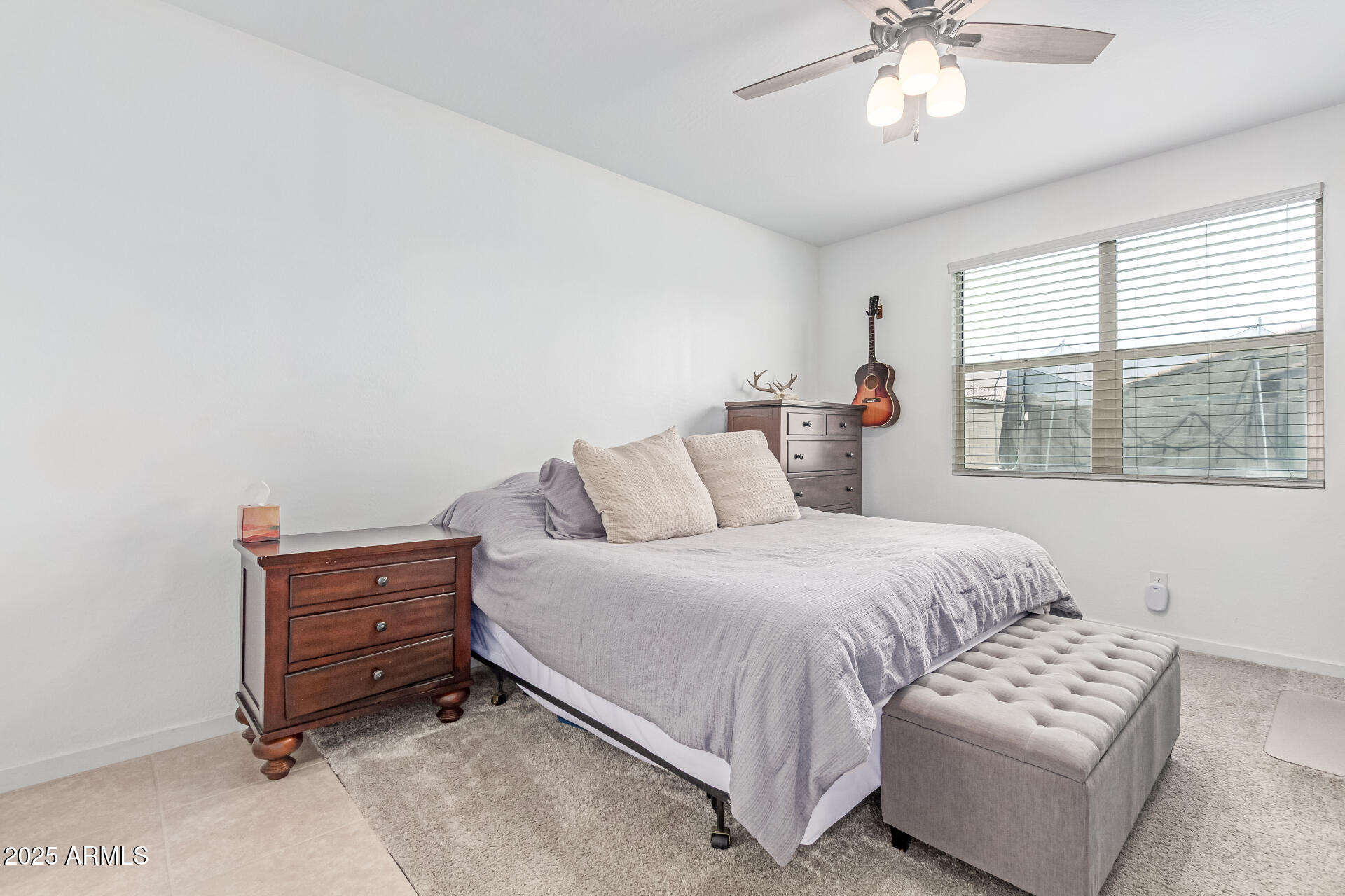 37287 North Azteca Road San Tan Valley, AZ 85140 - Photo 14 of 37 a bedroom with a bed and a chandelier