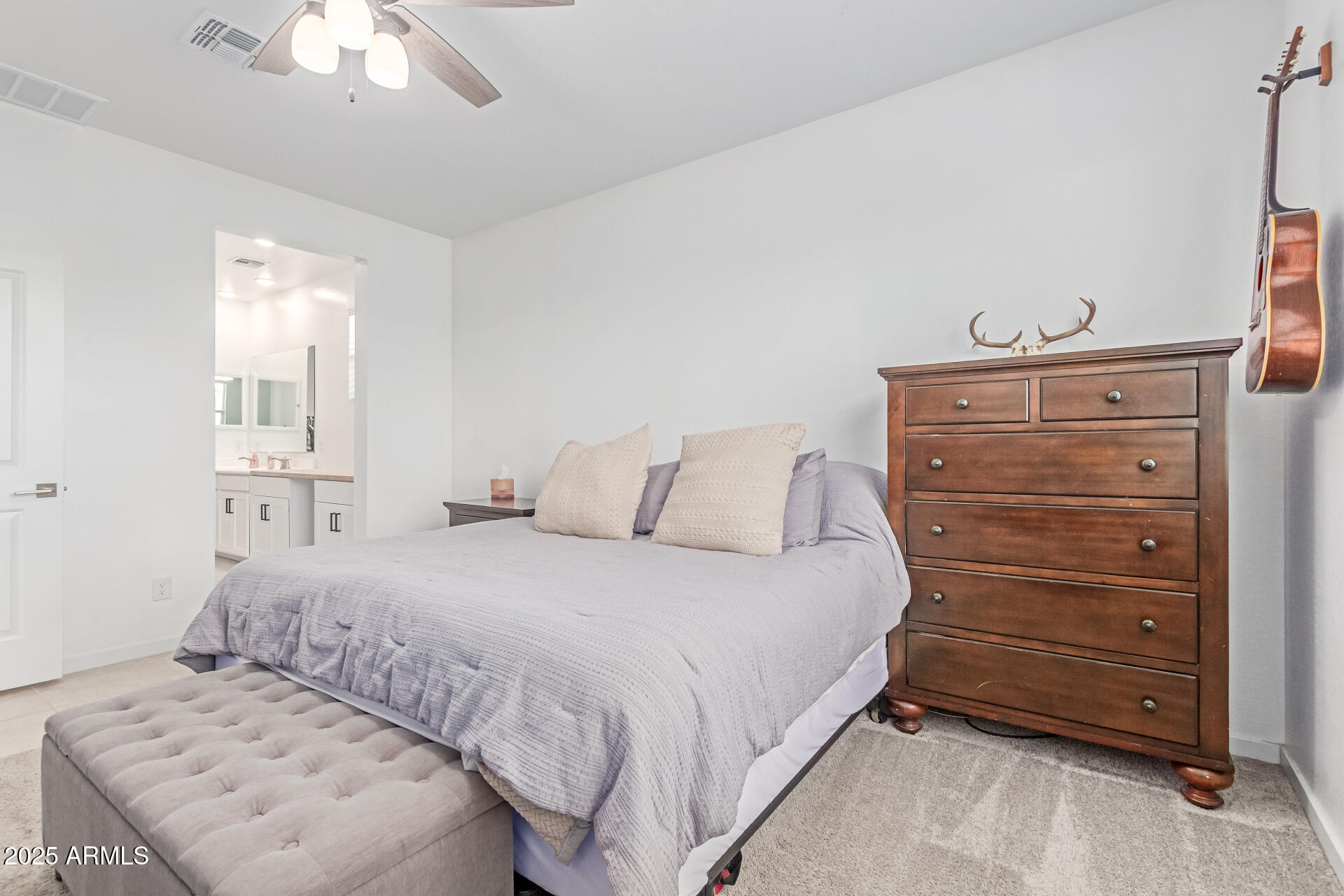 37287 North Azteca Road San Tan Valley, AZ 85140 - Photo 16 of 37 a bedroom with a bed and a chandelier