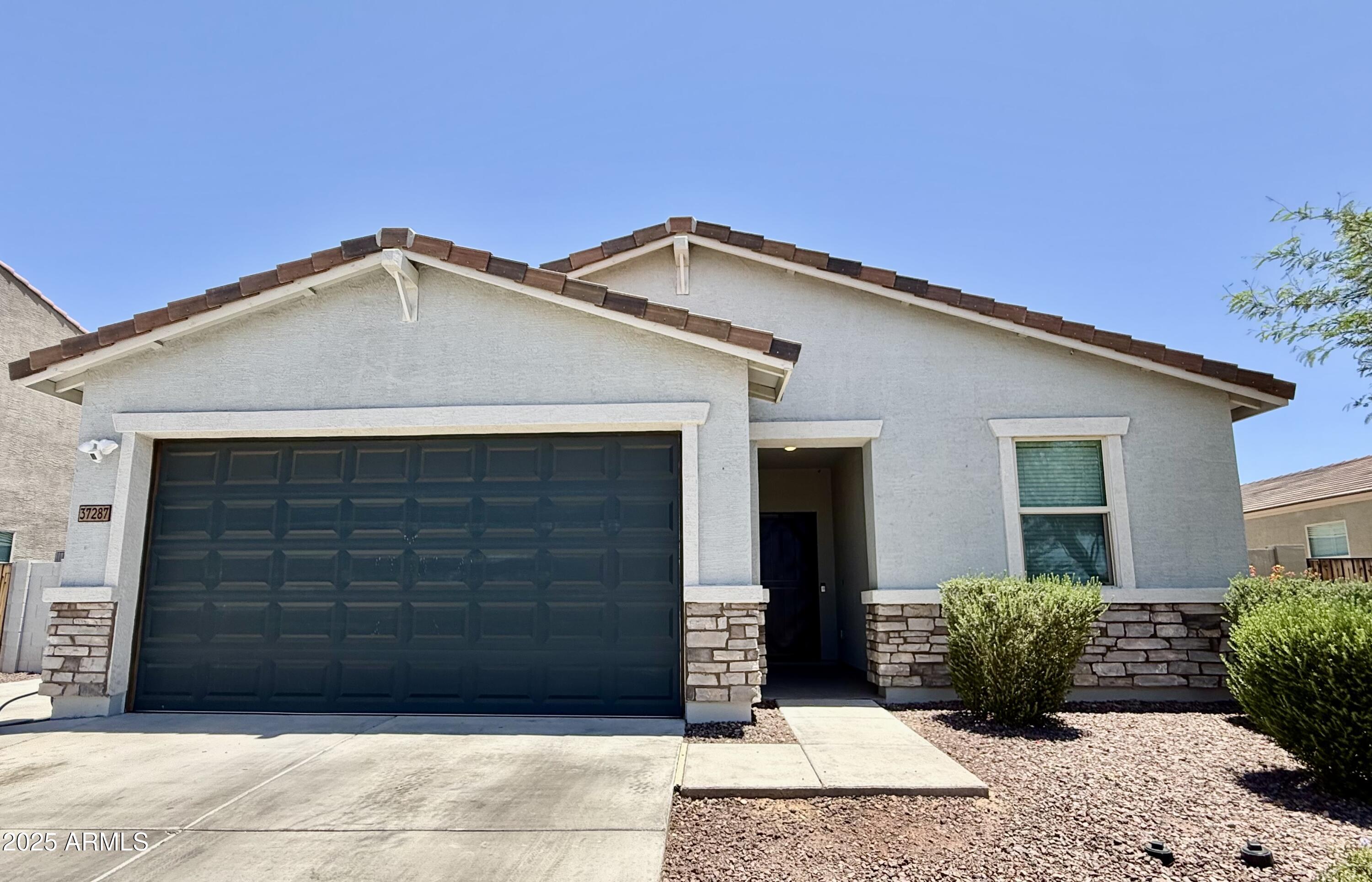 37287 North Azteca Road San Tan Valley, AZ 85140 - Photo 32 of 37 a front view of a house with a garage