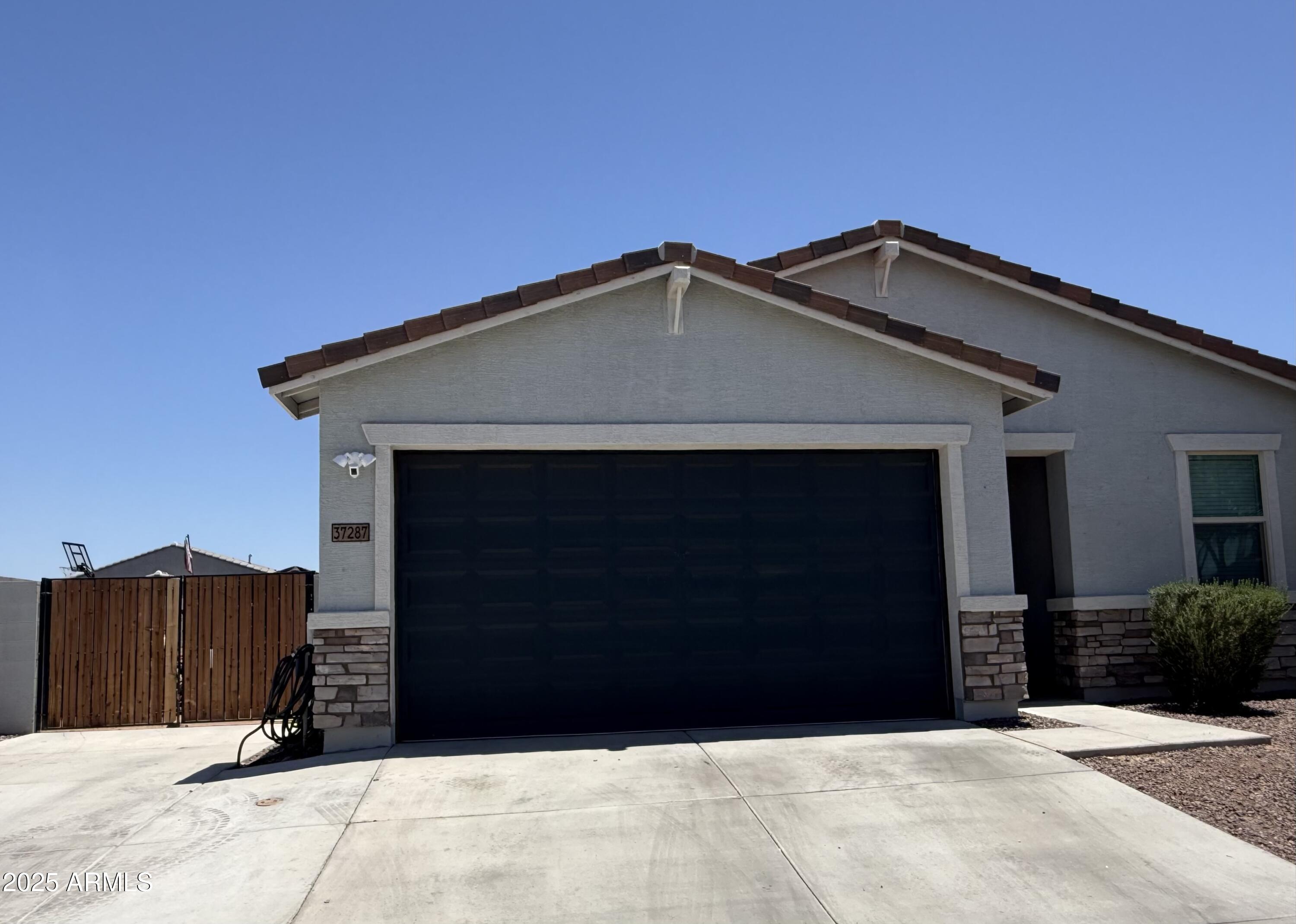 37287 North Azteca Road San Tan Valley, AZ 85140 - Photo 33 of 37 a front view of a house with a garage