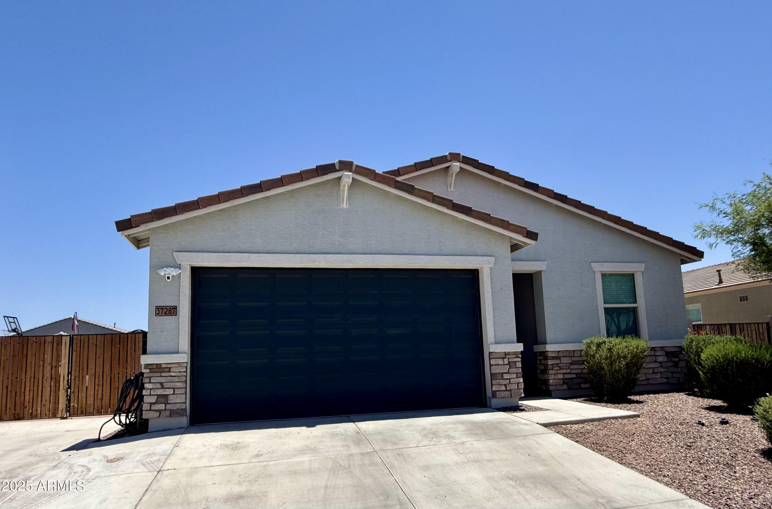 37287 North Azteca Road San Tan Valley, AZ 85140 - Photo 35 of 37 a front view of a house with a garage