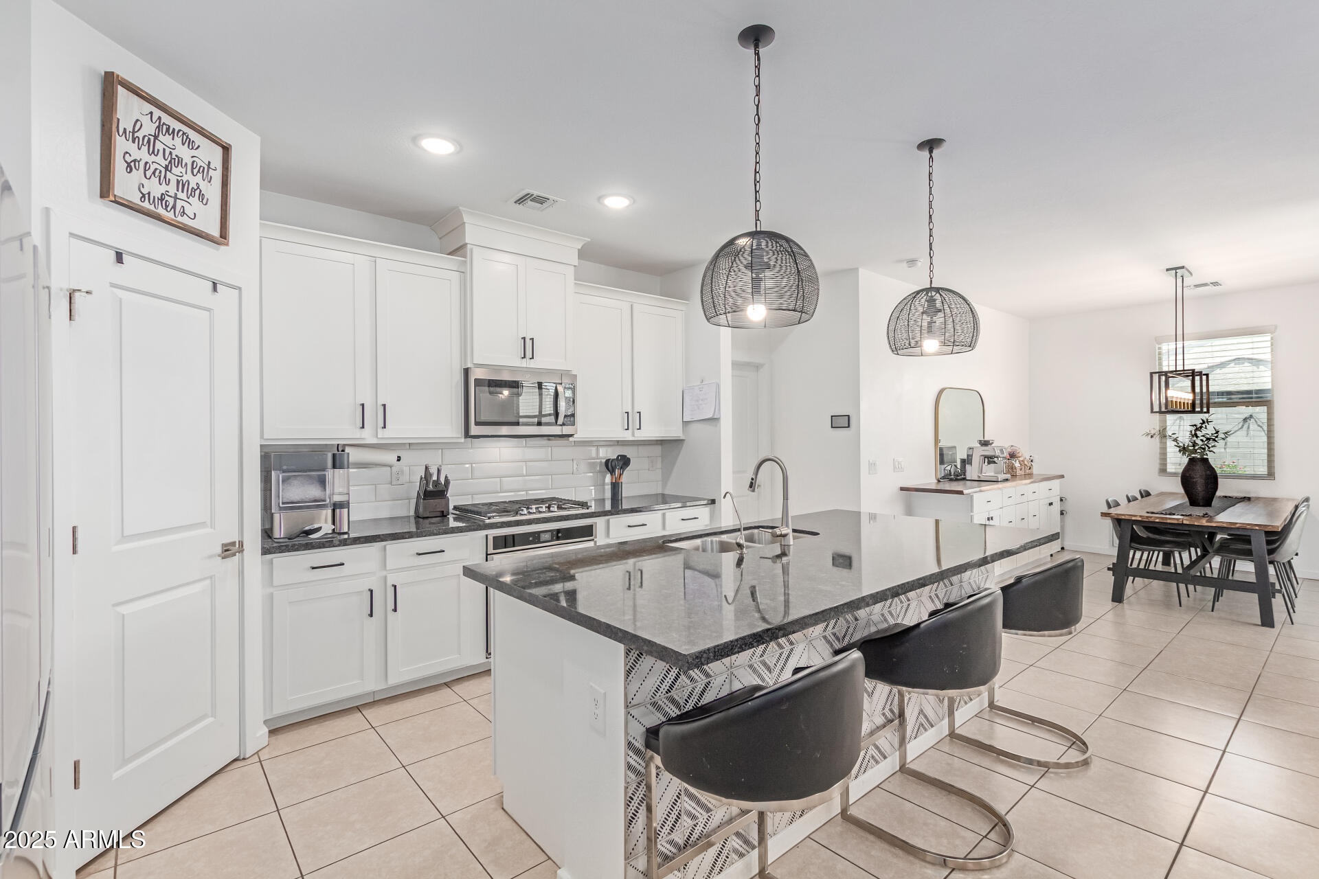 37287 North Azteca Road San Tan Valley, AZ 85140 - Photo 10 of 37 a large kitchen with stainless steel appliances kitchen island granite countertop a sink and cabinets