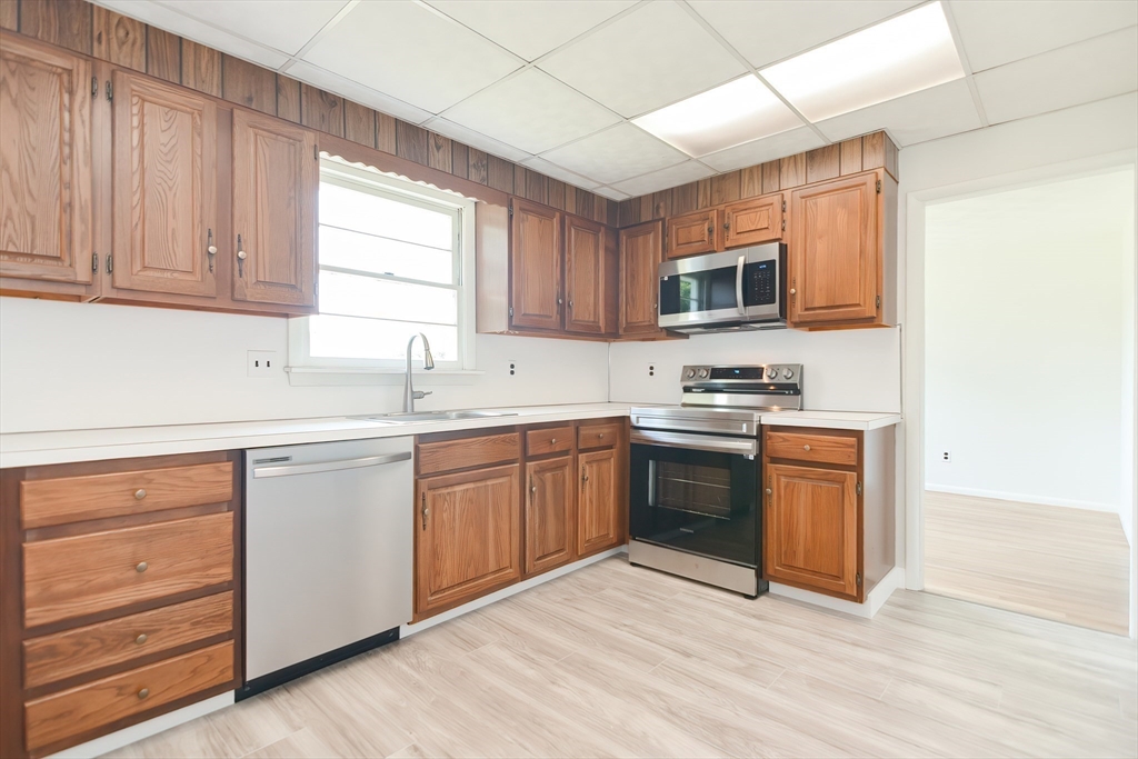 19 Ledgewood Road Framingham, MA 01701 - Photo 17 of 42 a kitchen with granite countertop a sink cabinets stainless steel appliances and a window