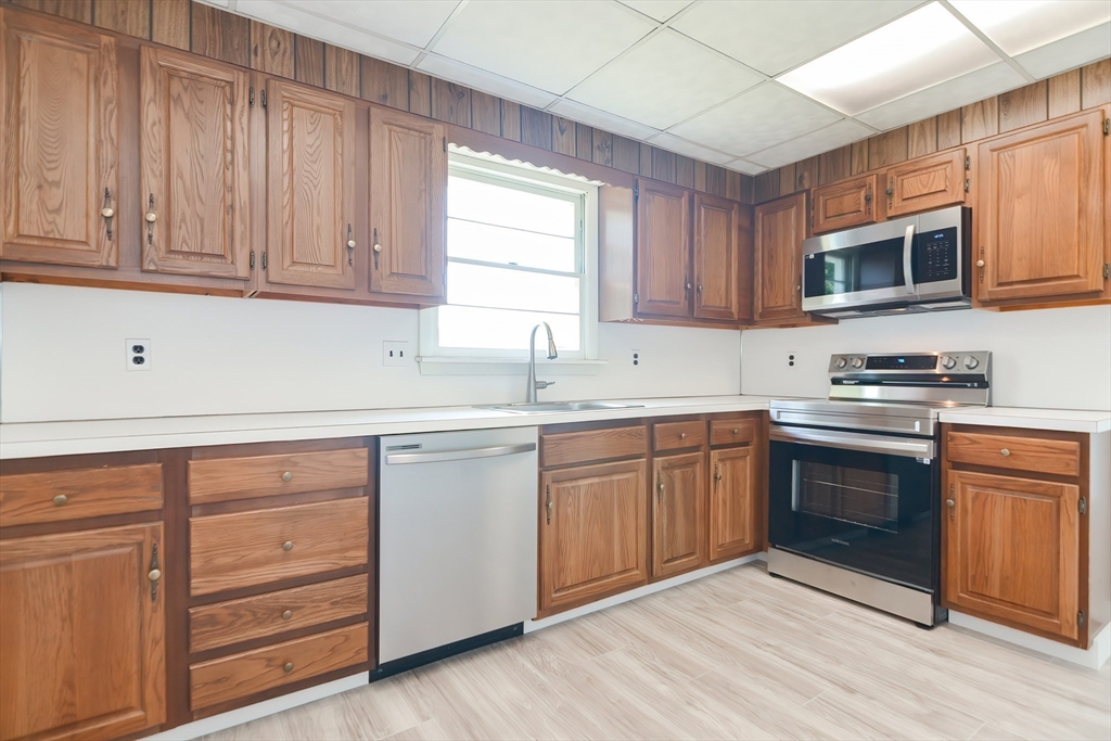 19 Ledgewood Road Framingham, MA 01701 - Photo 18 of 42 a kitchen with granite countertop cabinets stainless steel appliances and a window