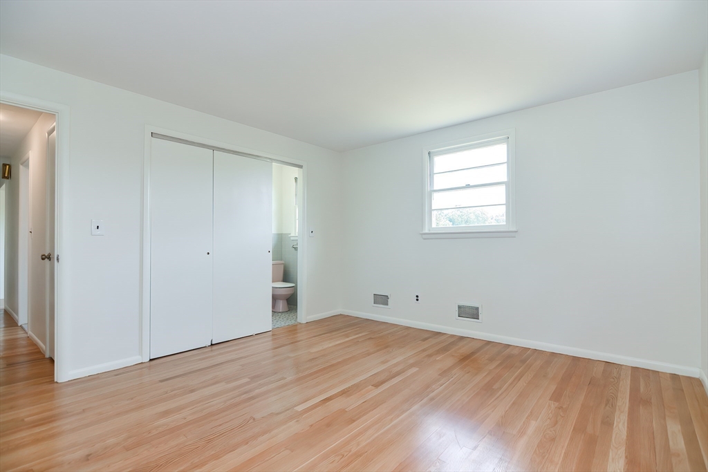 19 Ledgewood Road Framingham, MA 01701 - Photo 19 of 42 an empty room with wooden floor and windows