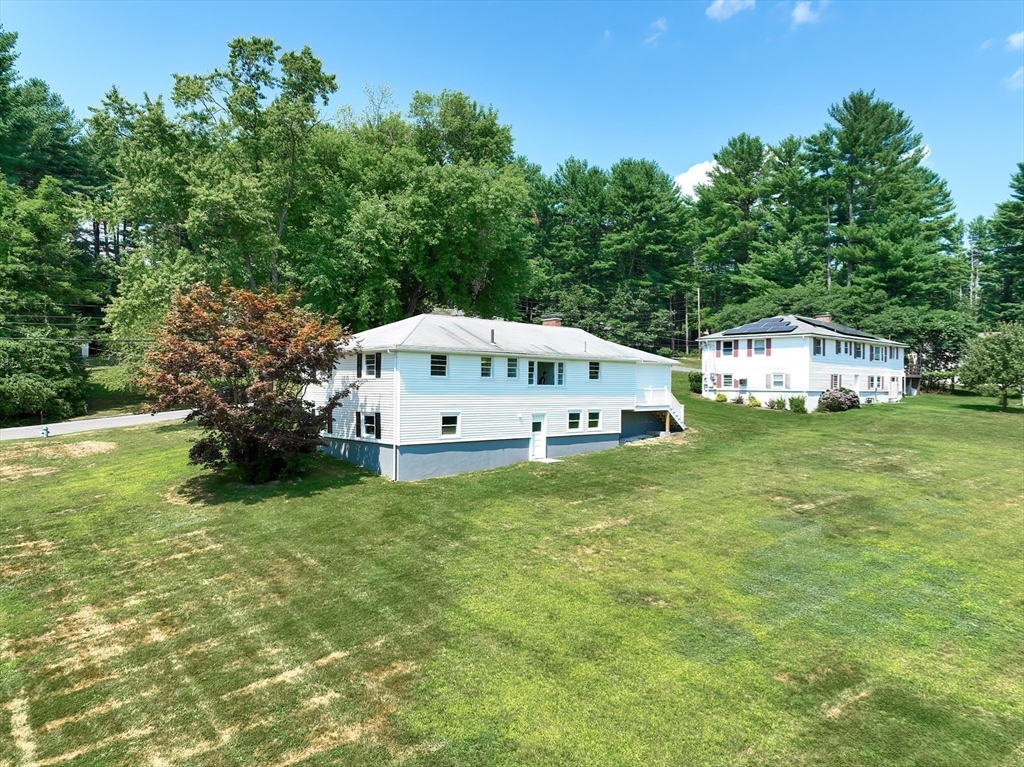 19 Ledgewood Road Framingham, MA 01701 - Photo 32 of 42 a white house sitting in the middle of a field