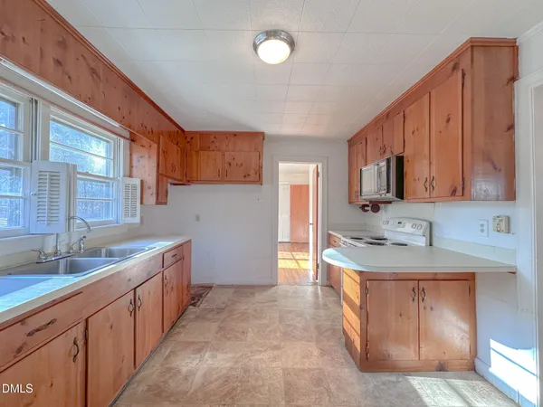 a kitchen with granite countertop white cabinets and sink