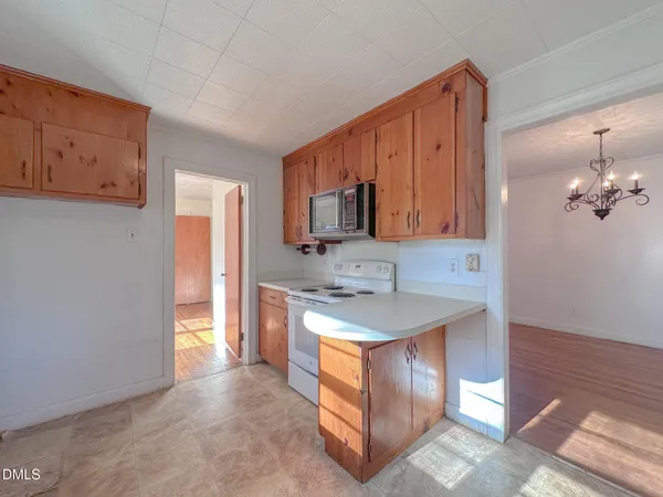 a kitchen with stainless steel appliances granite countertop a stove microwave and sink