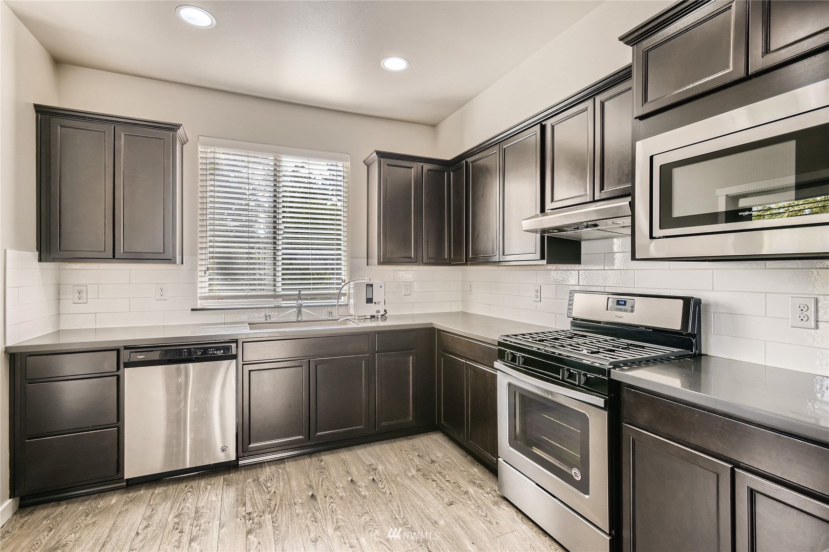 729 112th Street Southwest, Unit G1 Everett, WA 98204 - Photo 7 of 27 a kitchen with stainless steel appliances granite countertop a stove and a microwave