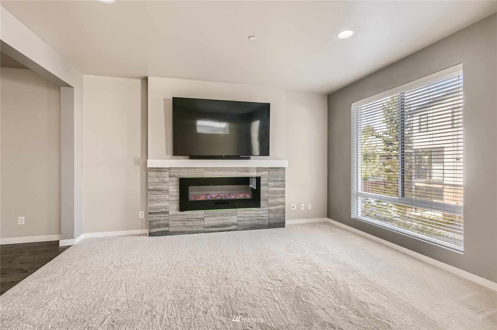 729 112th Street Southwest, Unit G1 Everett, WA 98204 - Photo 8 of 27 a living room with a fireplace and a flat screen tv