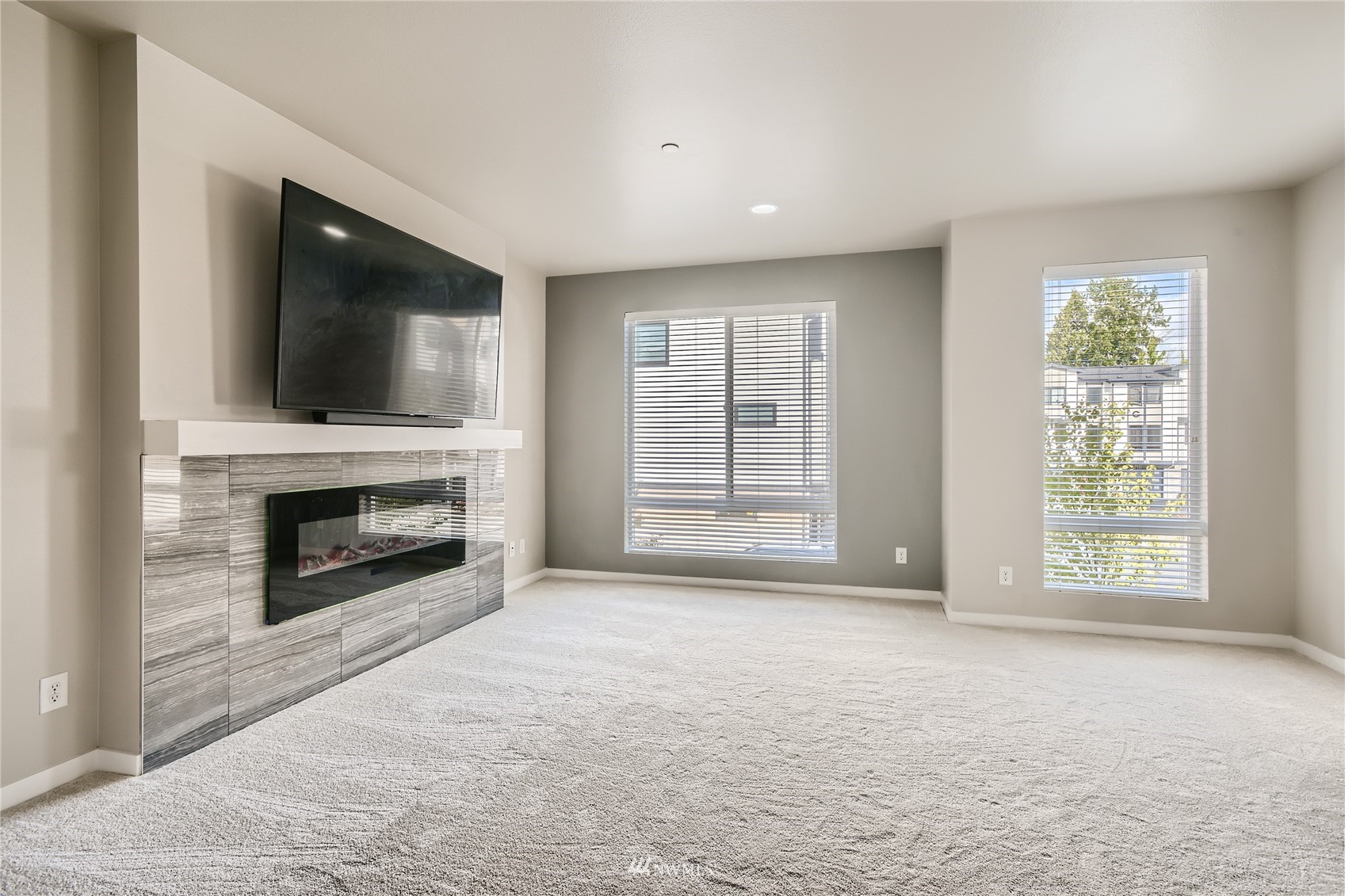 729 112th Street Southwest, Unit G1 Everett, WA 98204 - Photo 9 of 27 an empty room with windows and a fireplace