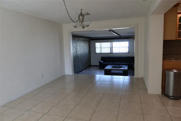 a view of an empty room and a window