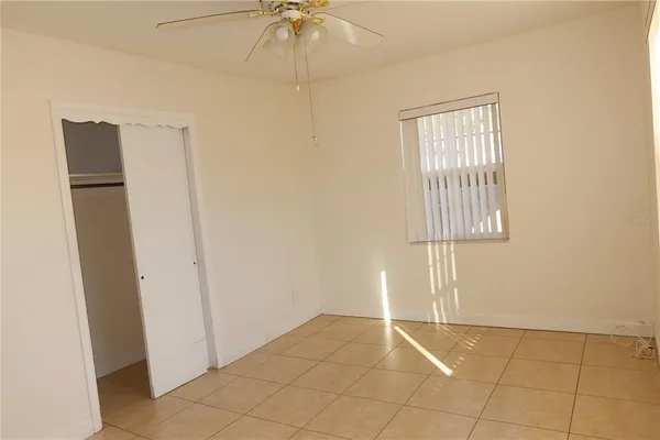 an empty room with windows and closet