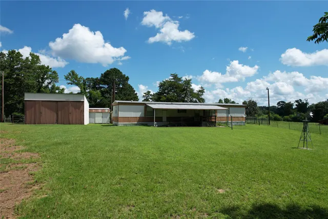 a view of a house with a backyard