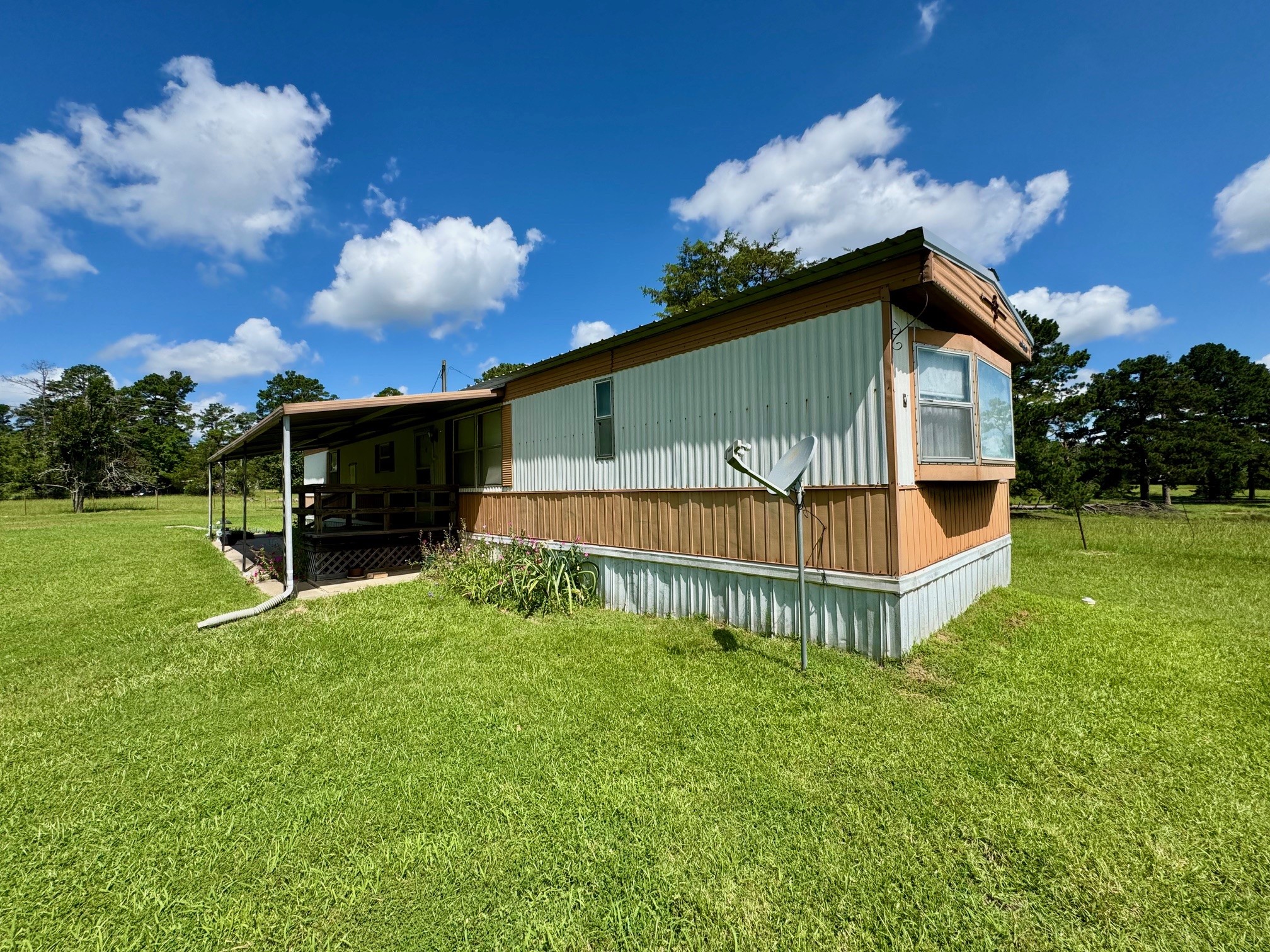 219 An County Road 185 Elkhart, TX 75839 - Photo 21 of 36 a backyard of a house with table and chairs