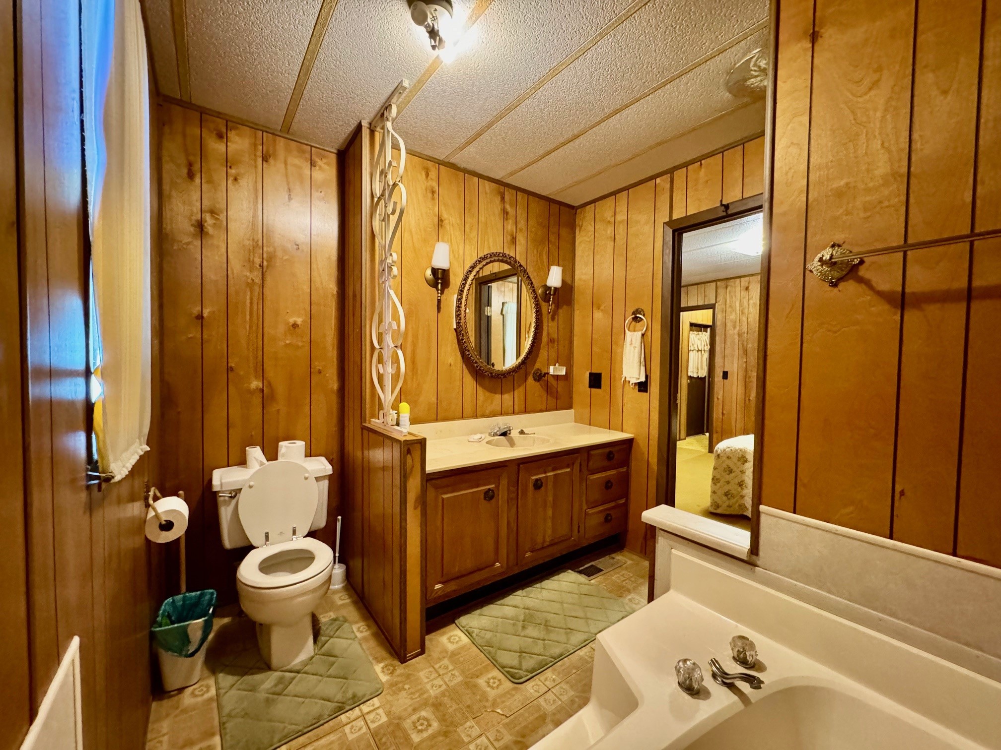 219 An County Road 185 Elkhart, TX 75839 - Photo 29 of 36 a spacious bathroom with a granite countertop tub sink and mirror