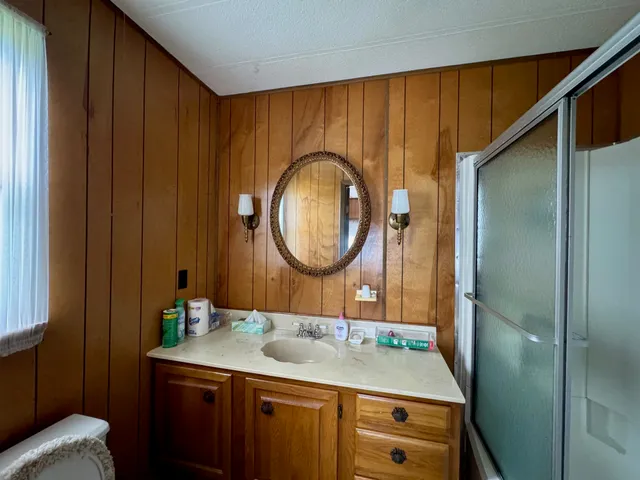 a view of a big yard with table and chairs plants and large tree