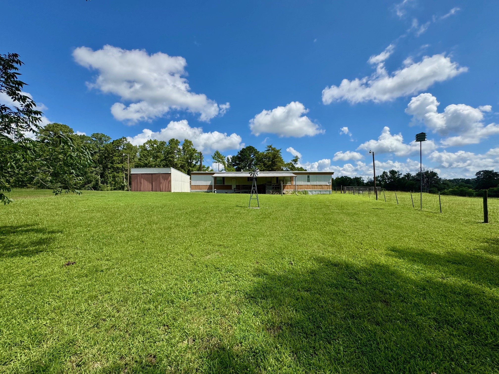 219 An County Road 185 Elkhart, TX 75839 - Photo 32 of 36 a view of a big yard with table and chairs plants and large tree