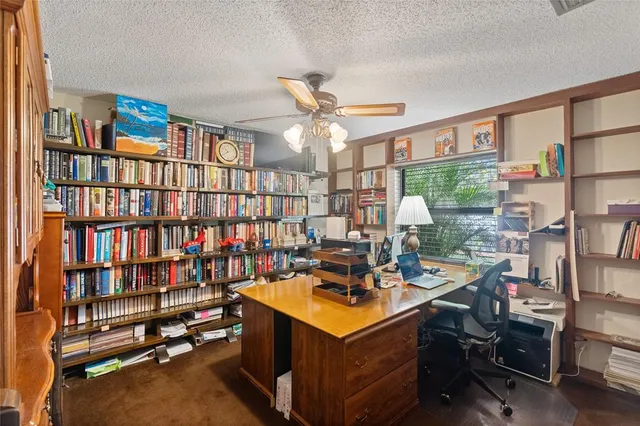 a room with furniture a bookshelf and a window