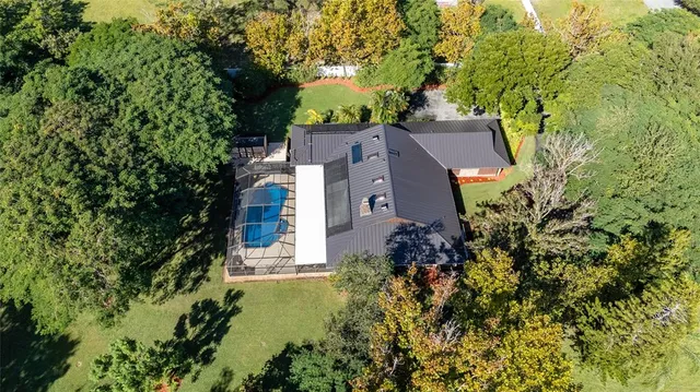 an aerial view of a house with a yard