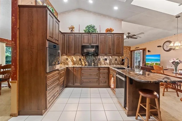a kitchen with stainless steel appliances a stove a sink and a refrigerator