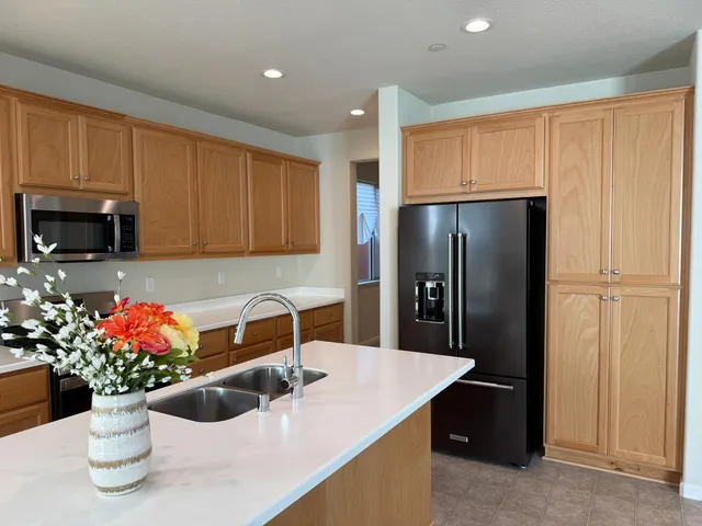 a kitchen with a refrigerator and a sink