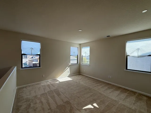 an empty room with windows and closet