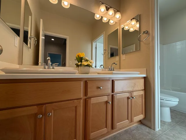 an empty room with closet and windows