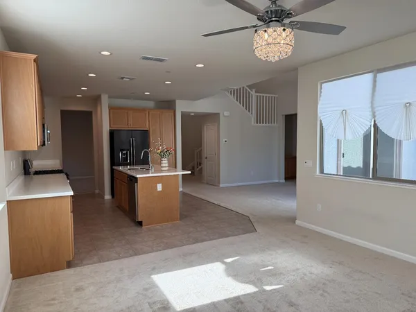 a view of kitchen with stainless steel appliances kitchen island a refrigerator and a stove top oven