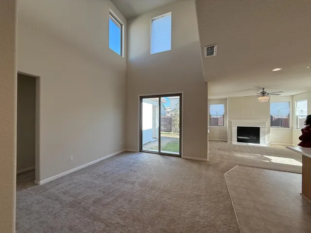 a view of empty room with fireplace
