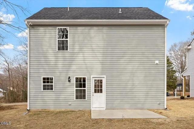 a kitchen with granite countertop white cabinets and appliances