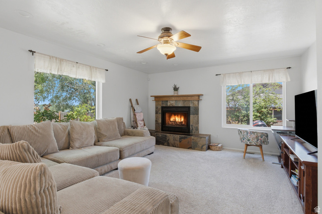 5788 Walden Ridge Drive Murray, UT 84123 - Photo 11 of 29 Living area featuring a stone-clad fireplace with a wood mantel