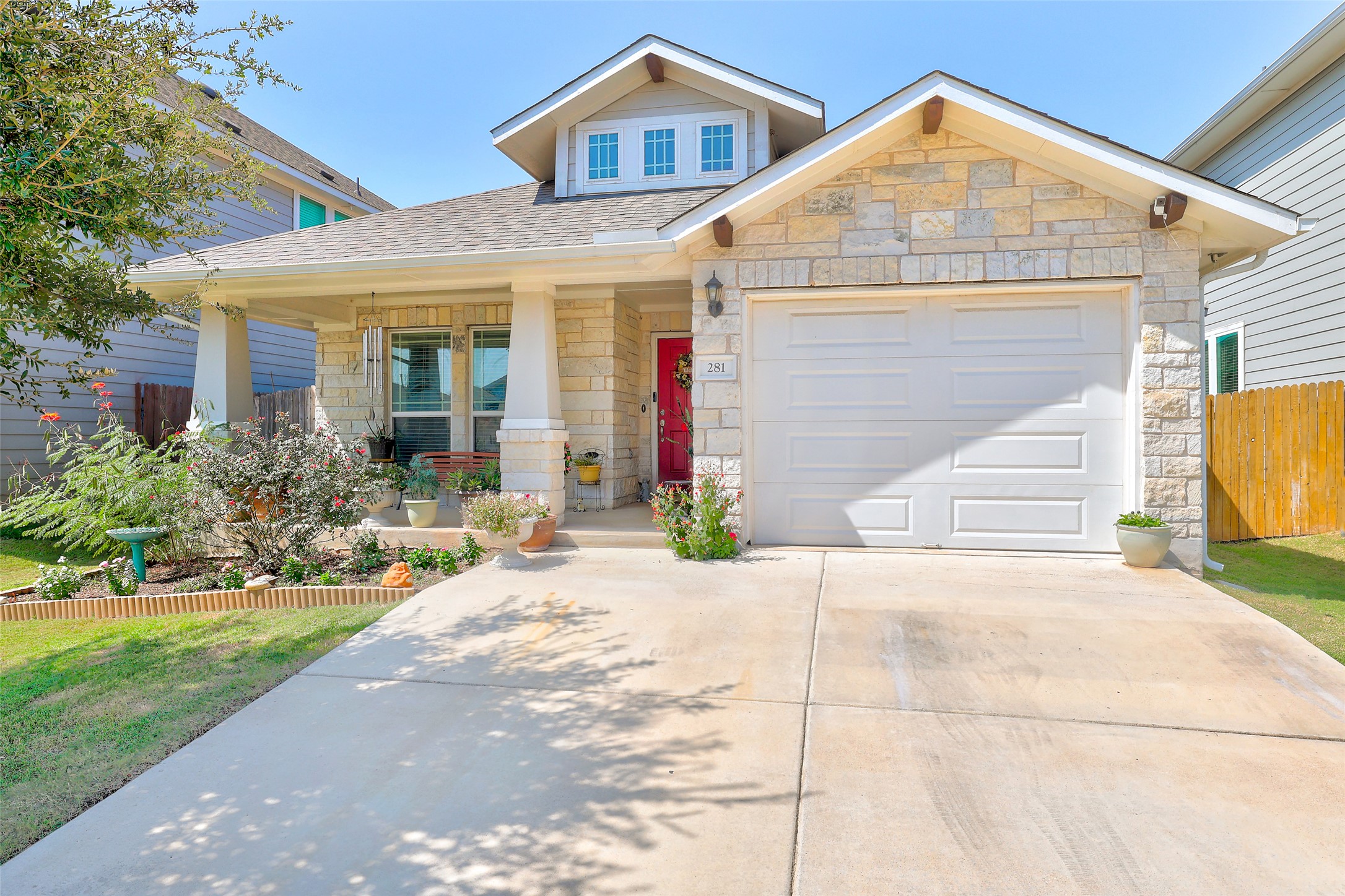 281 Gaida Loop Georgetown, TX 78628 - Photo 1 of 1 Stone and siding facade featuring an attached tandem 2-car garage and covered front porch