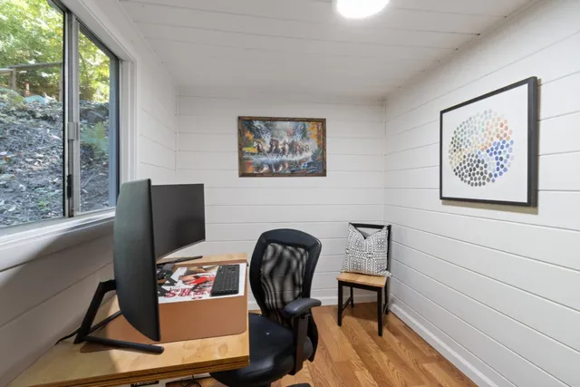 a bed sitting in a bedroom next to a window