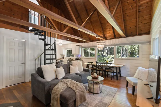 a living room with furniture a wooden floor and next to a window